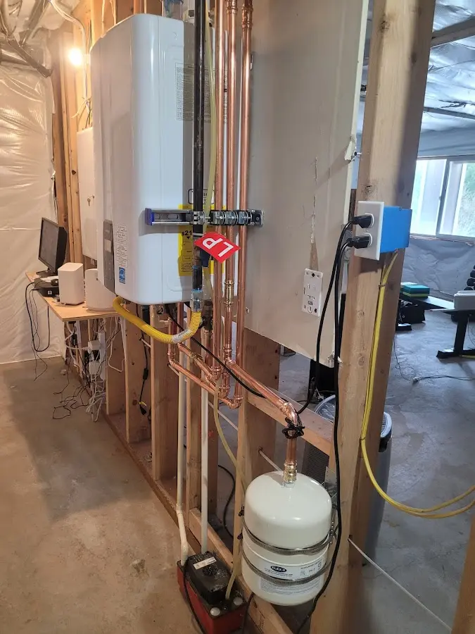 Licensed plumber repairing a kitchen sink in Belfast